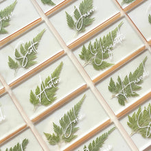 Load image into Gallery viewer, numerous pressed fern wedding place cards with gold lining
